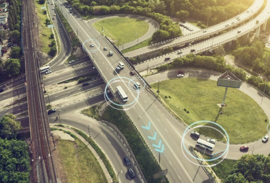 Autonomous Self Driving Cars Concept. Aerial view of cars and buses moving on city intersection and Artificial Intelligence scans road with sensors and control vehicles in traffic. Future Transportation concept.